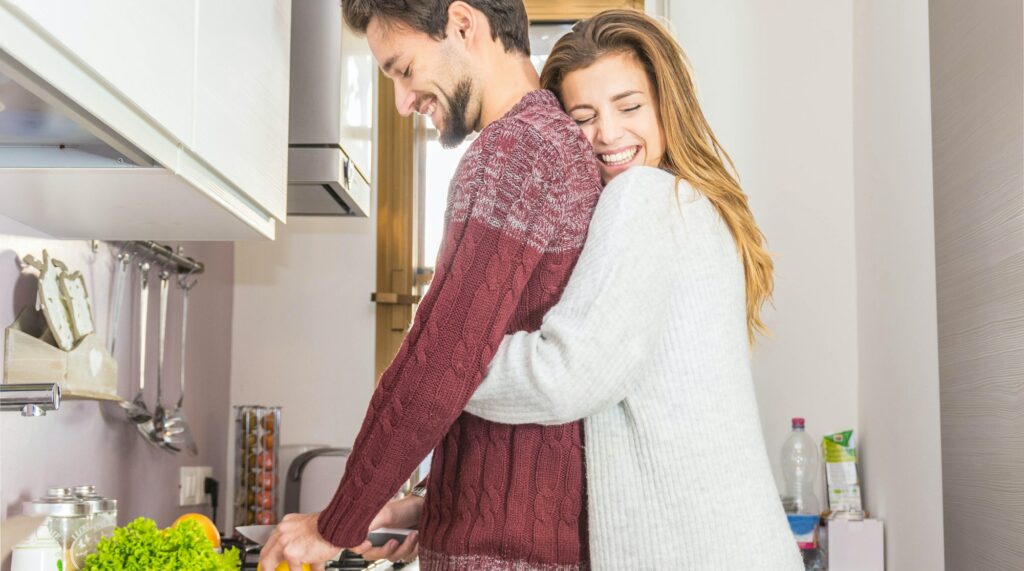 Loving couple cooking together in the kitchen at home